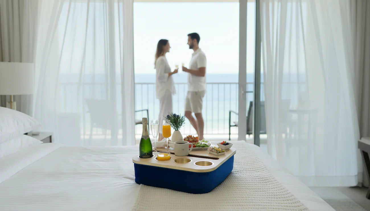 Couple in a bedroom with a breakfast tray and drinks, overlooking a scenic view using chillounge Premium Portable Tray